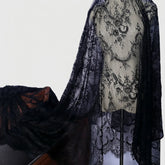 Black Chantilly lace fabric with soft eyelash floral design, perfect for wedding trims and DIY projects