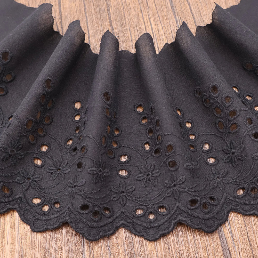 Black cotton eyelet lace trim flat lay showing fabric texture