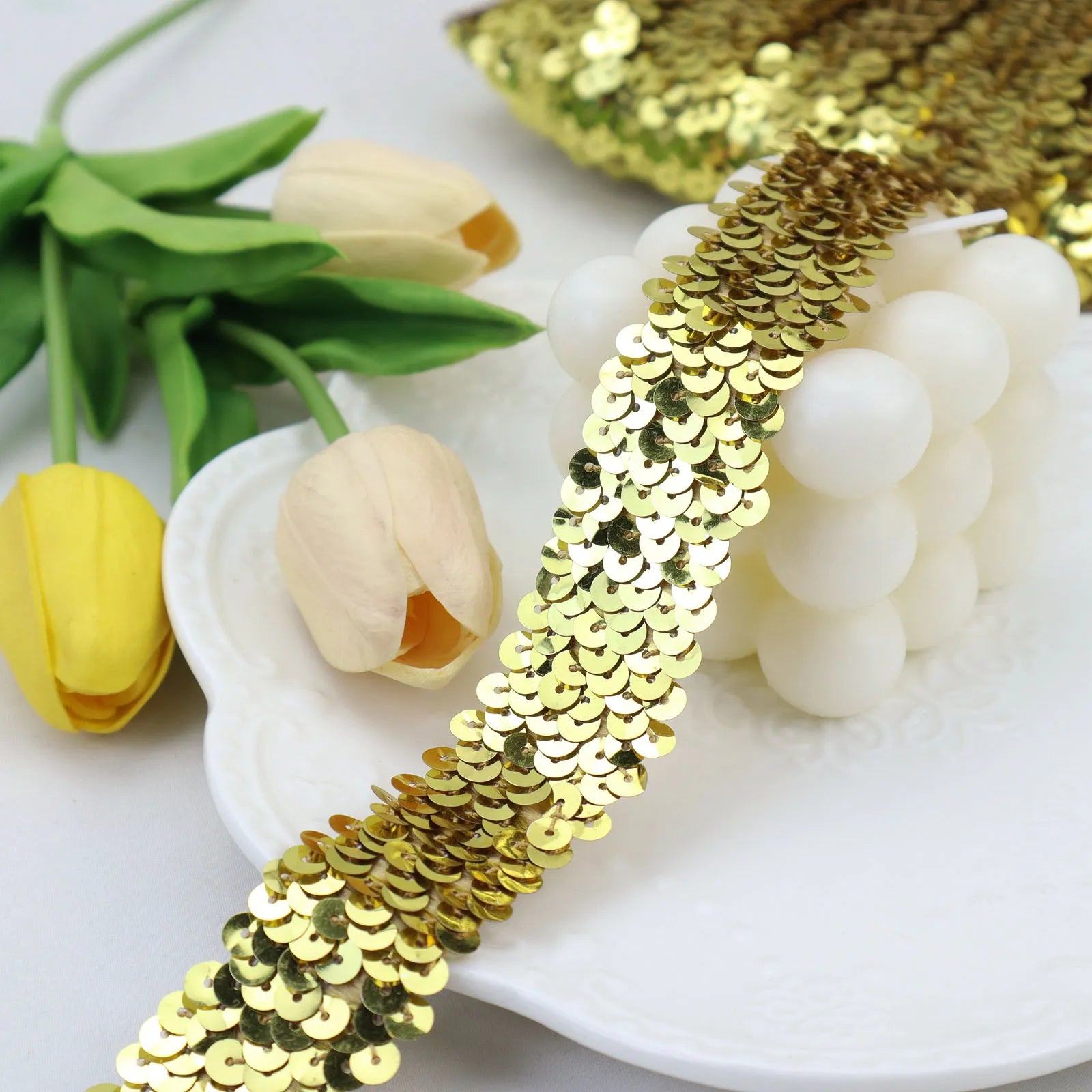 Gold elastic sequins trim featuring metallic stretch paillettes for costumes and fashion design