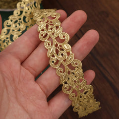 Close-up of Golden Ribbon gold lace trim showing the pattern and texture