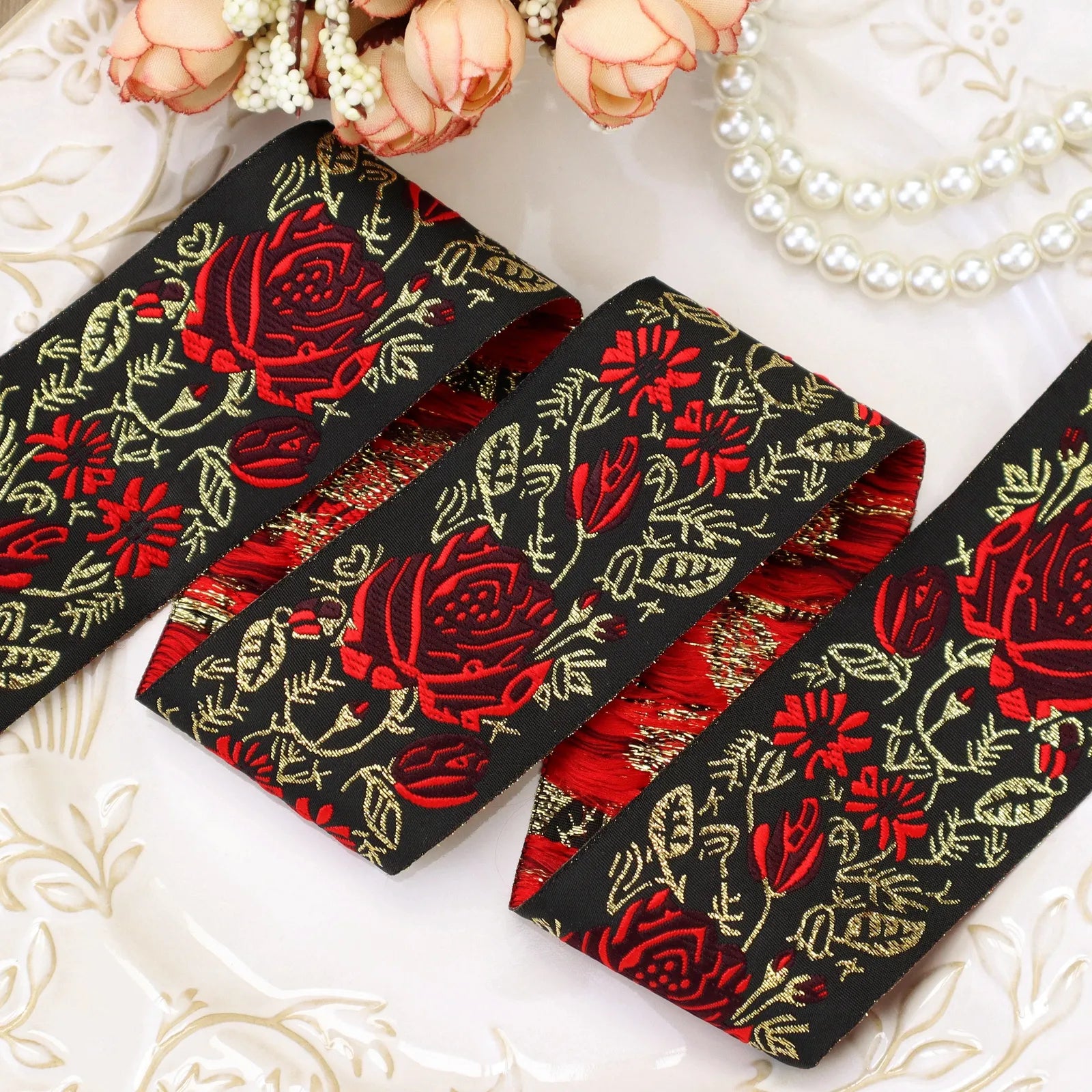 Front view of black and red floral embroidered jacquard ribbon texture