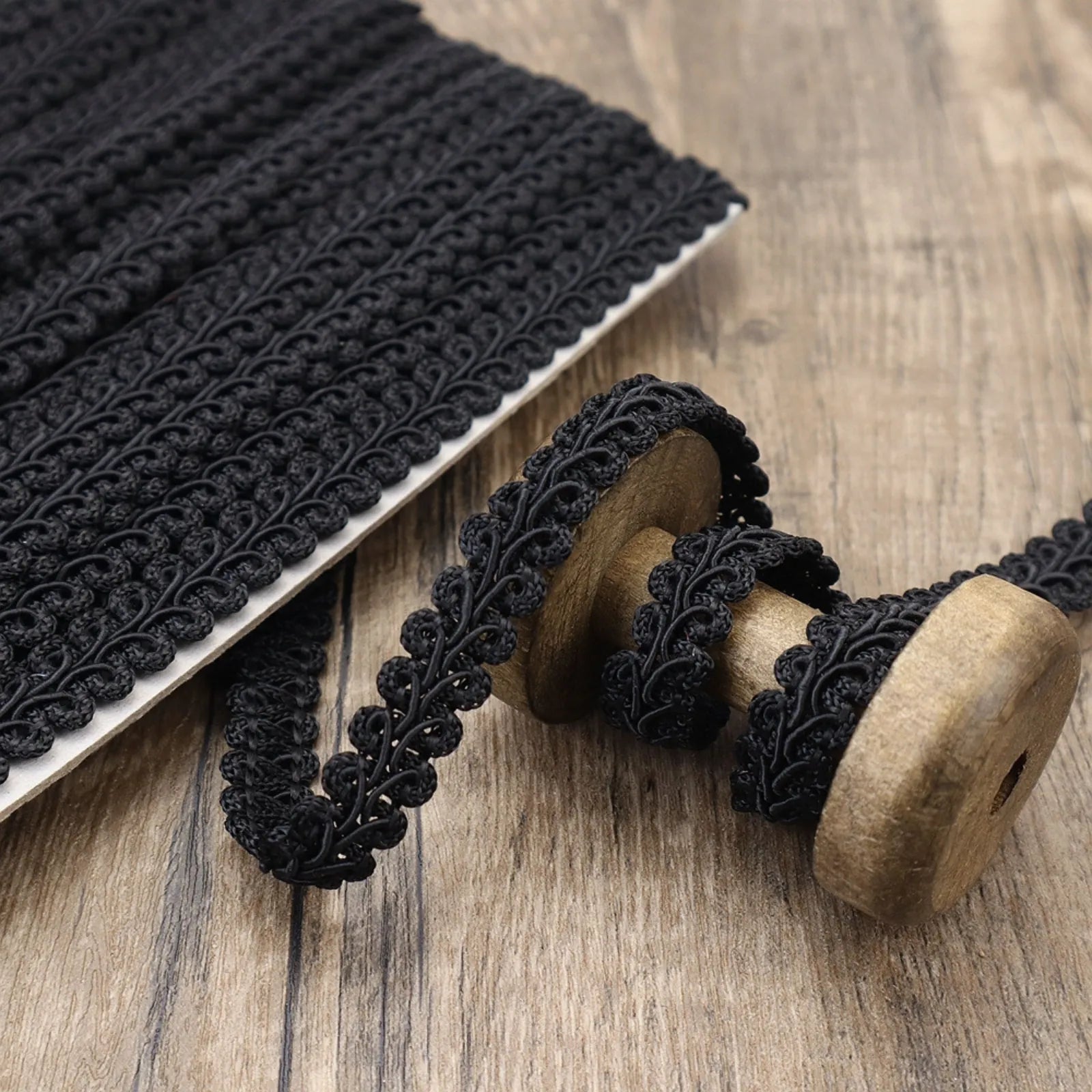 Close-up of the black Gimp Braid Trim showing its wavy texture, perfect for DIY crafts.