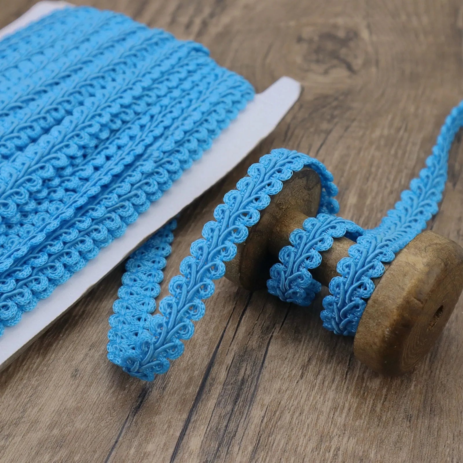 Close-up of the Light Blue Gimp Braid Trim showing its wavy texture, perfect for DIY crafts.