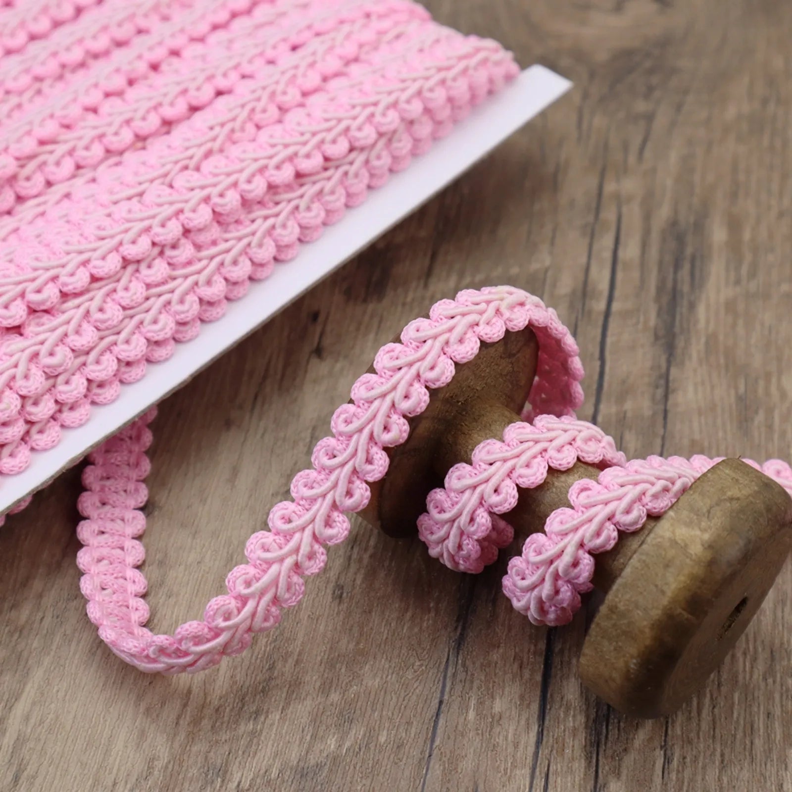 Close-up of the Pink Gimp Braid Trim showing its wavy texture, perfect for DIY crafts.
