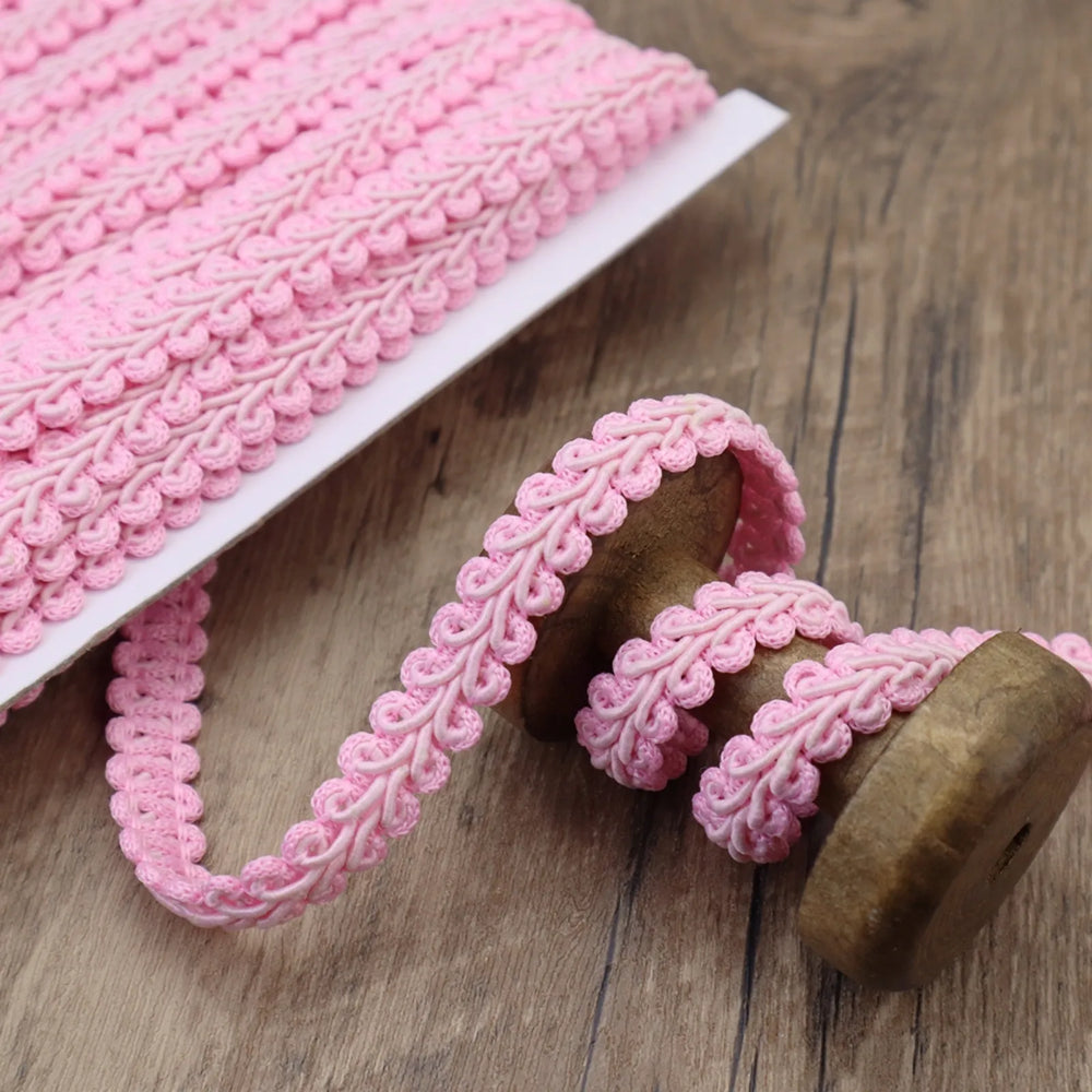 Close-up of the Pink Gimp Braid Trim showing its wavy texture, perfect for DIY crafts.
