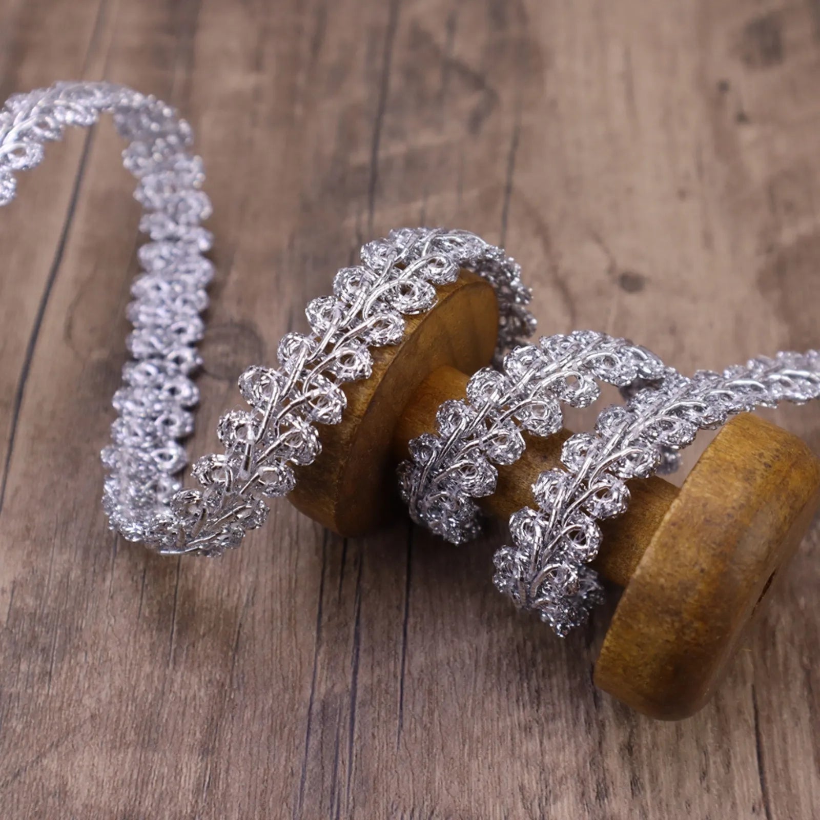 Close-up of the  Silvery Gimp Braid Trim showing its wavy texture, perfect for DIY crafts.
