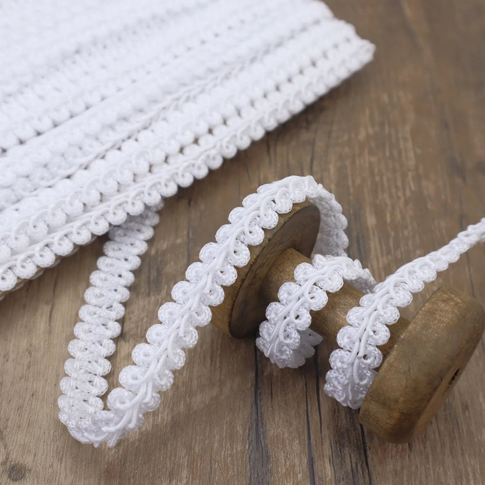 Close-up of the White Gimp Braid Trim showing its wavy texture, perfect for DIY crafts.
