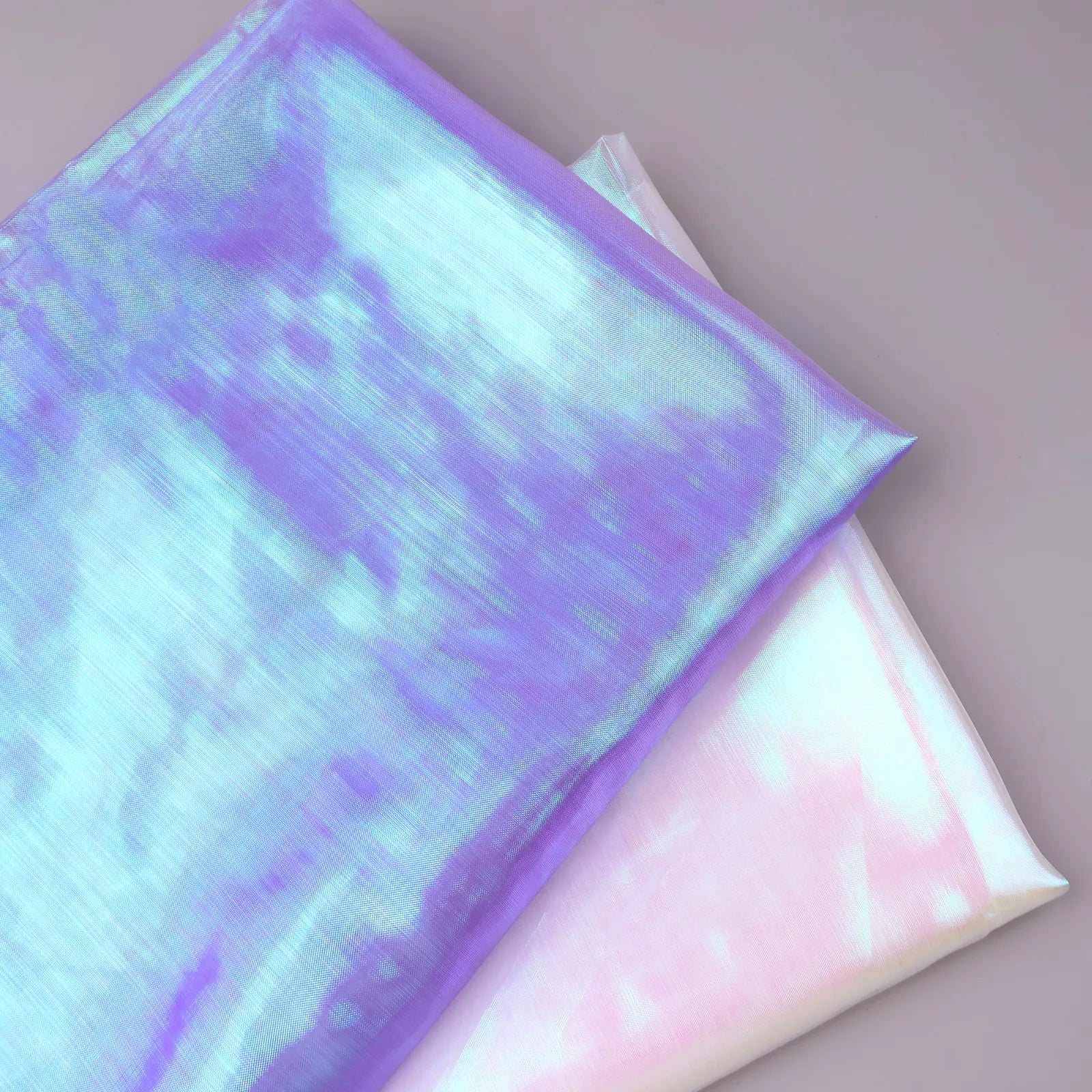 Iridescent chiffon fabric available in white and purple color options