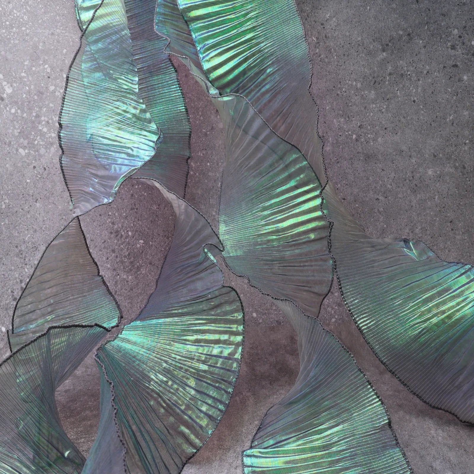 Detail of Iridescent Chiffon Ruffle Trim texture in Green, showing pleats and shimmer, ideal for DIY and dress decoration