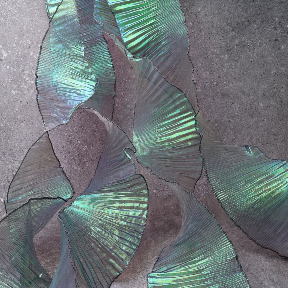 Detail of Iridescent Chiffon Ruffle Trim texture in Green, showing pleats and shimmer, ideal for DIY and dress decoration