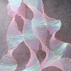 Detail of Iridescent Chiffon Ruffle Trim texture in Pink, perfect for costumes, sewing, and crafts