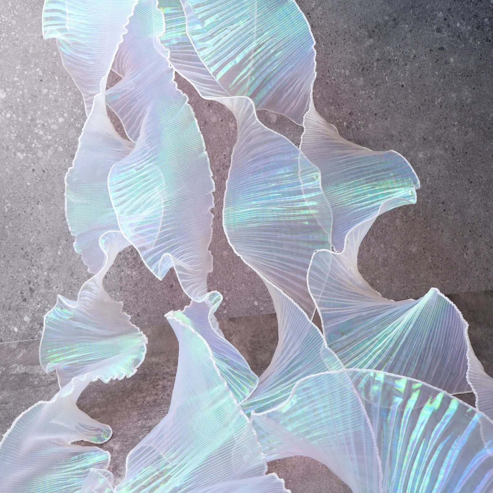 Detail of Iridescent Chiffon Ruffle Trim texture in White, soft, shiny, ideal for dress hems, bag decorations, and DIY projects