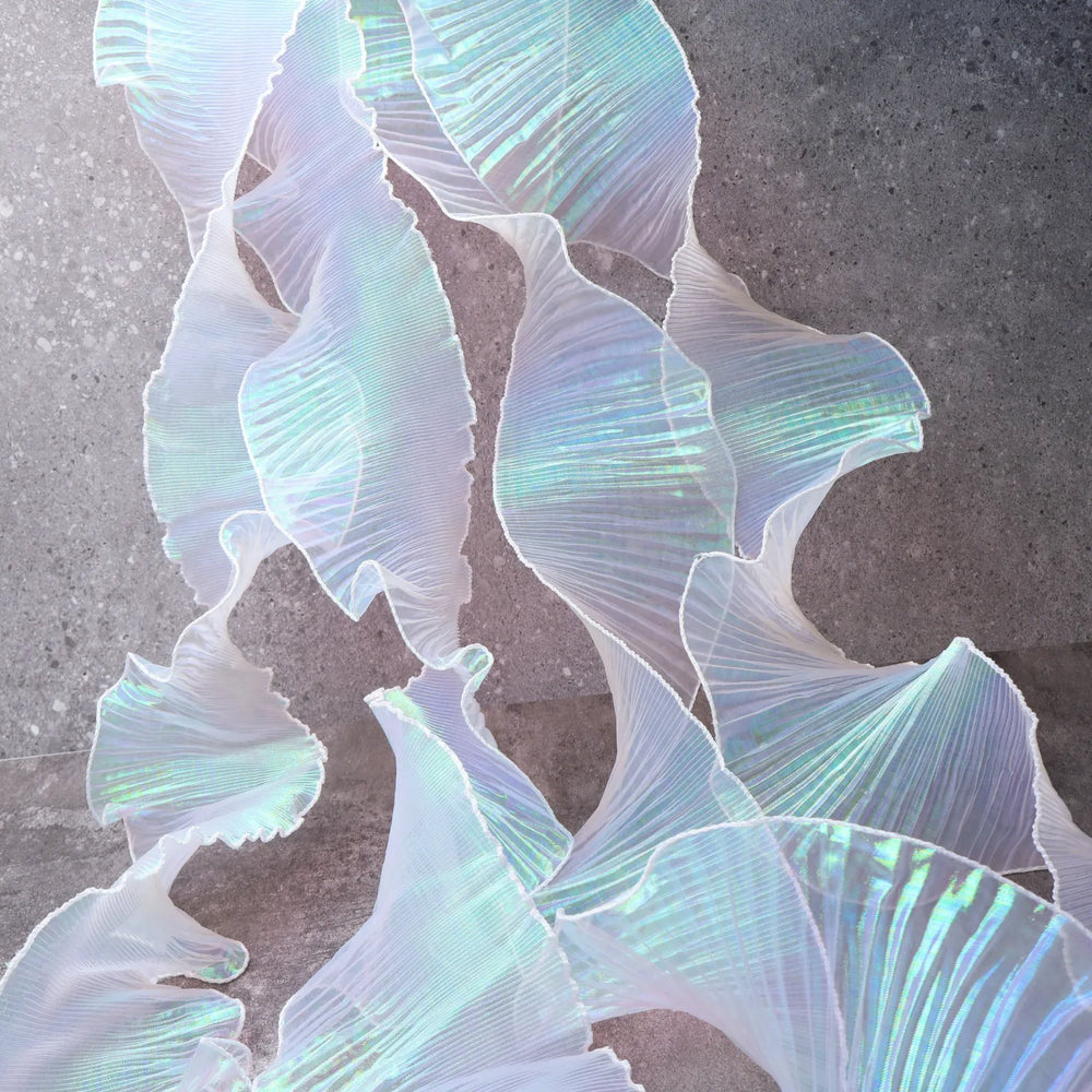 Detail of Iridescent Chiffon Ruffle Trim texture in White, soft, shiny, ideal for dress hems, bag decorations, and DIY projects